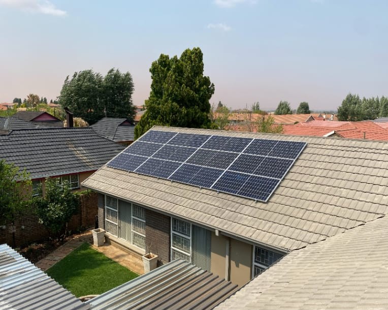 Solar installers working on pitched roof during photovoltaic system setup