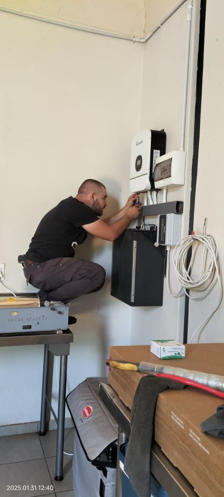 Solar installer connecting inverter during residential solar panel installation in Potchefstroom