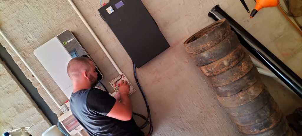 Solar technician connecting inverter during residential installation in North West Province